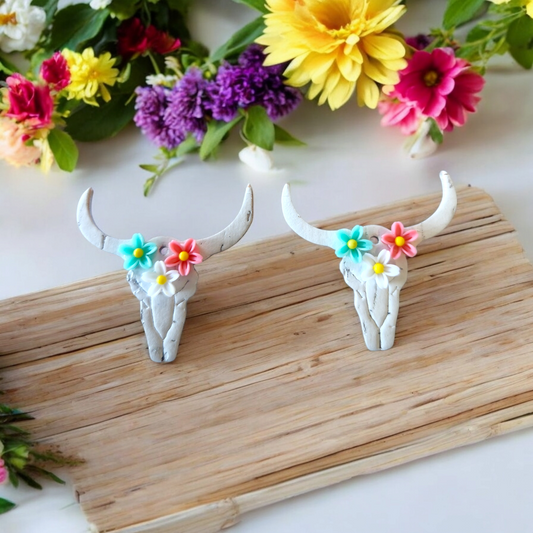 White Bull skulls with teal, white and pink flowers